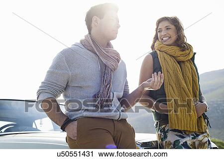 Young couple leaning on car chatting, Cape Town, Western Cape, South Africa View Large Photo Image Stock Image - Young couple leaning on car chatting, Cape Town, Western Cape, South Africa. Fotosearch
