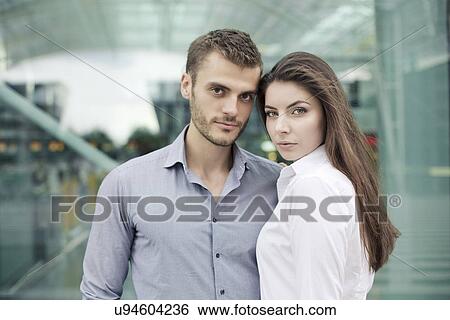 Young couple looking at camera, portrait View Large Photo Image Stock Photograph - Young couple looking at camera, portrait. Fotosearch