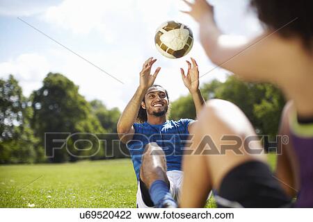 Young couple training with soccer ball in park View Large Photo Image Stock Image - Young couple training with soccer ball in park. Fotosearch