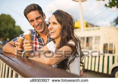 Young couple with ice cream cones View Large Photo Image Stock Photo - Young couple with ice cream cones. Fotosearch