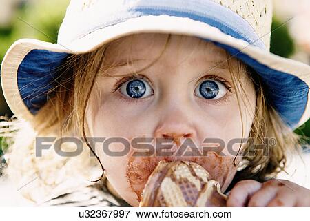 Young girl eating ice cream cone View Large Photo Image Stock Photo - Young girl eating ice cream cone. Fotosearch