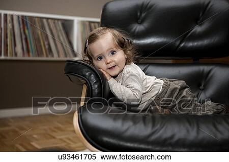 Young girl relaxing in leather armchair View Large Photo Image Stock Photography - Young girl relaxing in leather armchair. Fotosearch