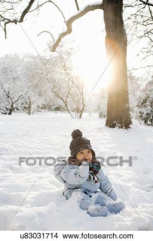 Young girl sitting in snow View Large Photo Image Picture - Young girl sitting in snow. Fotosearch