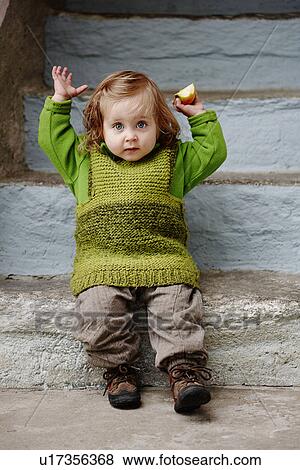 Young girl sitting on stone steps, portrait View Large Photo Image Stock Photo - Young girl sitting on stone steps, portrait. Fotosearch