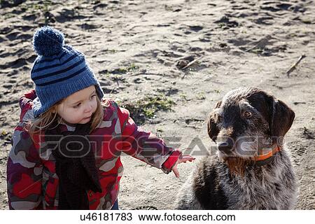 Young girl stroking dog View Large Photo Image Stock Image - Young girl stroking dog. Fotosearch
