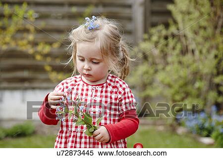 Young girl wearing gingham dress holding flowers View Large Photo Image Stock Photography - Young girl wearing gingham dress holding flowers. Fotosearch