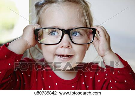 Stock Image - Young girl wearing glasses. Fotosearch