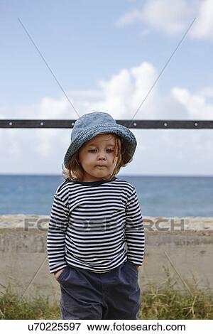 Young girl wearing hat and striped top View Large Photo Image Stock Photo - Young girl wearing hat and striped top. Fotosearch