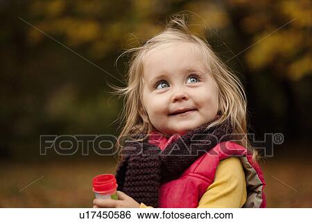 Stock Photograph - Young girl with blonde hair, portrait. Fotosearch