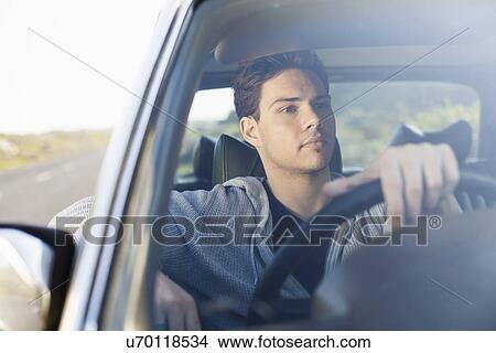 Young man gazing out of car windscreen, Cape Town, Western Cape, South Africa View Large Photo Image Picture - Young man gazing out of car windscreen, Cape Town, Western Cape, South Africa. Fotosearch