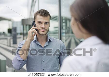Young man on cell phone View Large Photo Image Stock Image - Young man on cell phone. Fotosearch