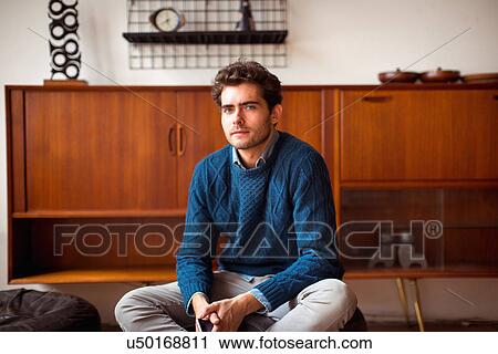 Young man wearing blue sweater, portrait View Large Photo Image Stock Image - Young man wearing blue sweater, portrait. Fotosearch