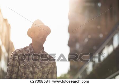 Picture - Young man wearing hat and checked shirt. Fotosearch