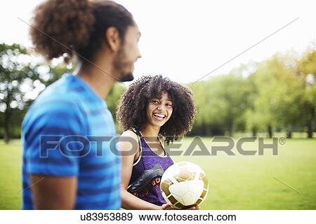 Young soccer couple chatting in park View Large Photo Image Stock Photo - Young soccer couple chatting in park. Fotosearch