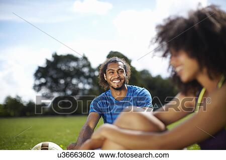 Young soccer couple taking a break in park View Large Photo Image Stock Image - Young soccer couple taking a break in park. Fotosearch