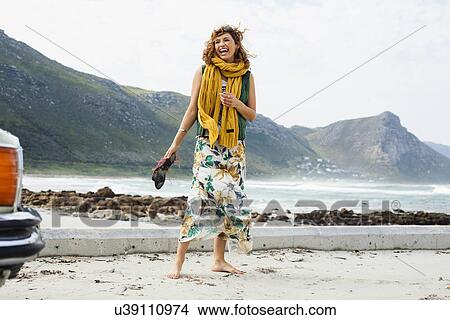 Picture - Young woman laughing on beach, Cape Town, Western Cape, South Africa. Fotosearch
