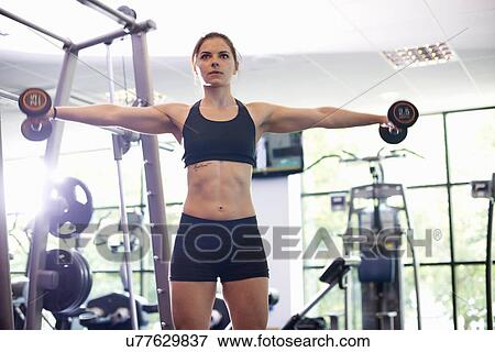 Young woman lifting hand weights View Large Photo Image Stock Photo - Young woman lifting hand weights. Fotosearch
