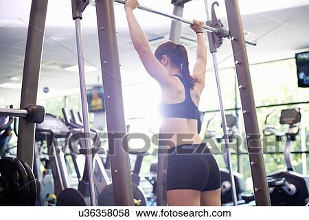 Young woman lifting weights View Large Photo Image Stock Photo - Young woman lifting weights. Fotosearch