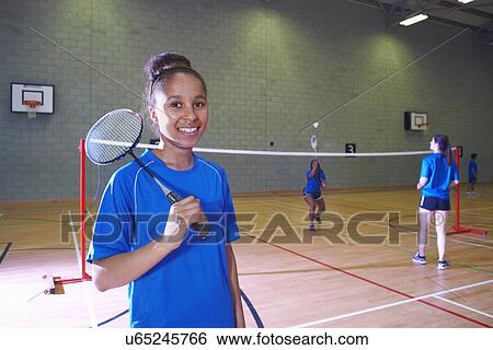 Stock Photograph - Young woman on badminton court, portrait. Fotosearch