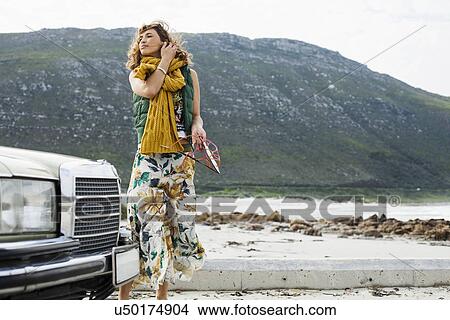 Young woman on breezy beach, Cape Town, Western Cape, South Africa View Large Photo Image Picture - Young woman on breezy beach, Cape Town, Western Cape, South Africa. Fotosearch