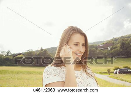 Young woman on cell phone View Large Photo Image Stock Image - Young woman on cell phone. Fotosearch