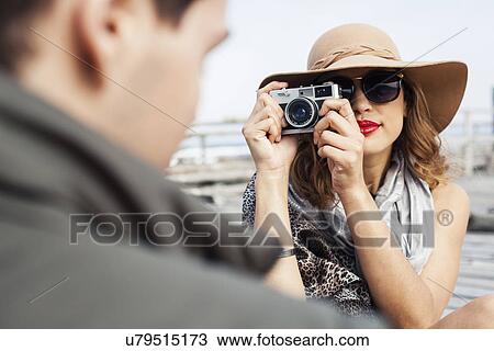 Young woman photographing boyfriend on coastal pier, Cape Town, Western Cape, South Africa View Large Photo Image Stock Image - Young woman photographing boyfriend on coastal pier, Cape Town, Western Cape, South Africa. Fotosearch