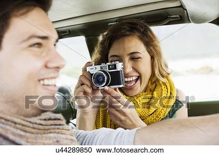 Young woman photographing boyfriend whilst driving, Cape Town, Western Cape, South Africa View Large Photo Image Stock Image - Young woman photographing boyfriend whilst driving, Cape Town, Western Cape, South Africa. Fotosearch