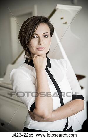 Stock Photography - Young woman resting chin on hand, portrait. Fotosearch