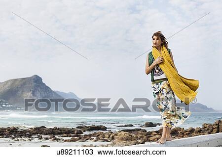 Young woman walking along cement block on beach, Cape Town, Western Cape, South Africa View Large Photo Image Stock Image - Young woman walking along cement block on beach, Cape Town, Western Cape, South Africa. Fotosearch