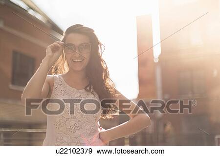 Stock Photo - Young woman wearing sunglasses. Fotosearch