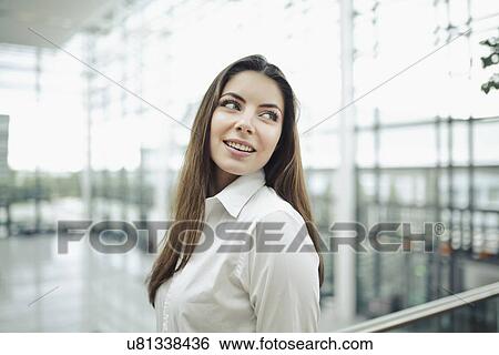 Young woman wearing white shirt, portrait View Large Photo Image Stock Photograph - Young woman wearing white shirt, portrait. Fotosearch