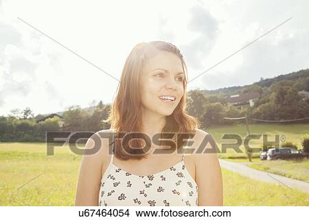 Young woman with brown hair, looking away View Large Photo Image Picture - Young woman with brown hair, looking away. Fotosearch