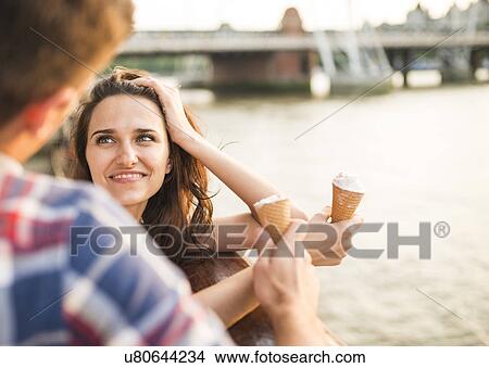 Picture - Young woman with ice cream cone. Fotosearch