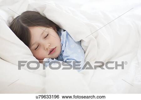 Girl asleep in bed View Large Photo Image Stock Photograph - Girl asleep in bed. Fotosearch