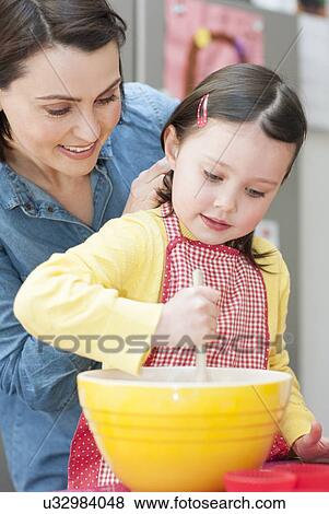 Mother and daughter baking View Large Photo Image Stock Photo - Mother and daughter baking. Fotosearch