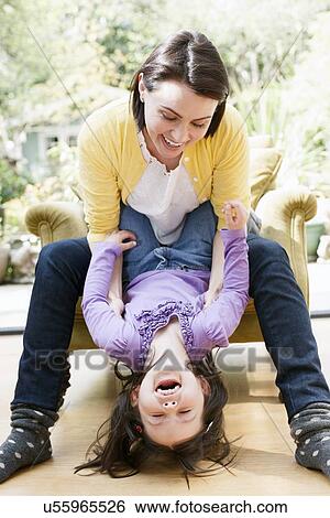 Stock Photograph - Mother playing with daughter. Fotosearch