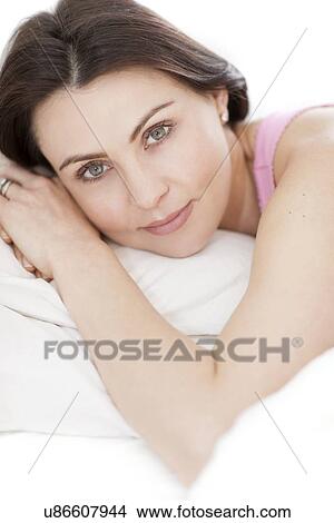Picture - Woman lying in bed. Fotosearch