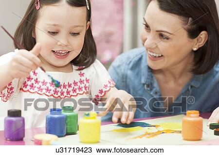 Stock Image - Young girl painting. Fotosearch