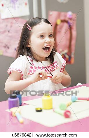 Stock Image - Young girl painting. Fotosearch