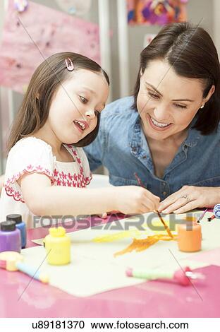 Stock Image - Young girl painting. Fotosearch