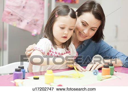 Young girl painting View Large Photo Image Stock Photo - Young girl painting. Fotosearch