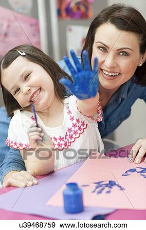 Young girl painting View Large Photo Image Stock Photo - Young girl painting. Fotosearch
