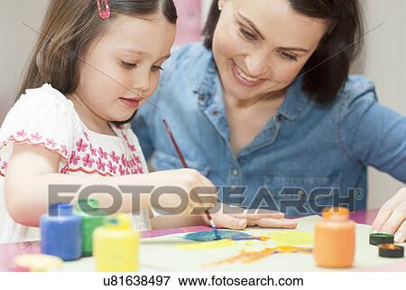 Stock Photo - Young girl painting. Fotosearch