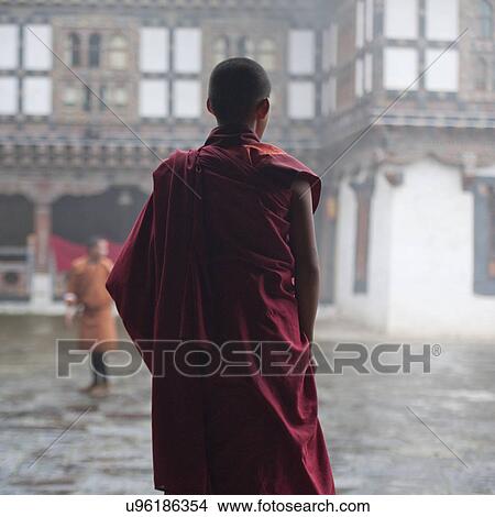 Picture - Back view of a monk at Trongsa Dzong. Fotosearch