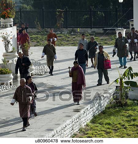 Bhutanese people walking along a pathway in Thimphu, Bhutan View Large Photo Image Stock Photo - Bhutanese people walking along a pathway in Thimphu, Bhutan. Fotosearch