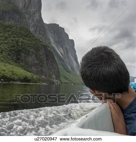 Boy enjoying Western Brook Pond fjord boat tour, Gros Morne National Park, Newfoundland and Labrador, Canada View Large Photo Image Stock Photo - Boy enjoying Western Brook Pond fjord boat tour, Gros Morne National Park, Newfoundland and Labrador, Canada. Fotosearch