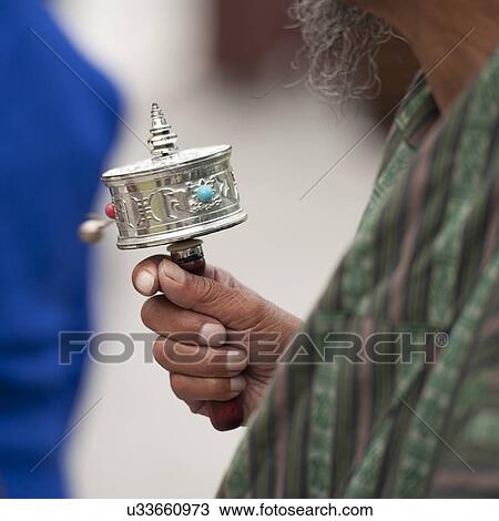 Stock Image - Buddhist worshipper at the National Memorial Chortan in Bhutan, Asia. Fotosearch