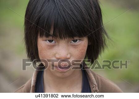 Stock Image - Close-up of a boy in Gangte Monastery, Phobjikha Valley, Bhutan. Fotosearch
