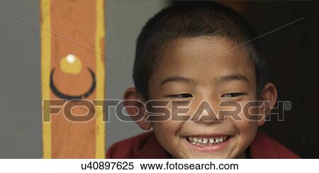 Stock Photography - Close-up of a boy smiling in Zilukha Nunnery, Thimphu, Bhutan. Fotosearch