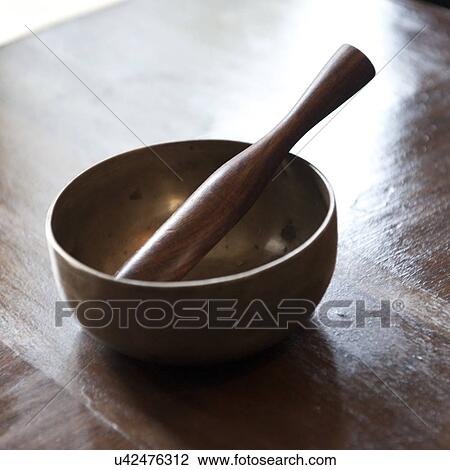 Stock Image - Close-up of a mortar and pestle in Como Resort, Uma Paro, Paro District, Bhutan. Fotosearch